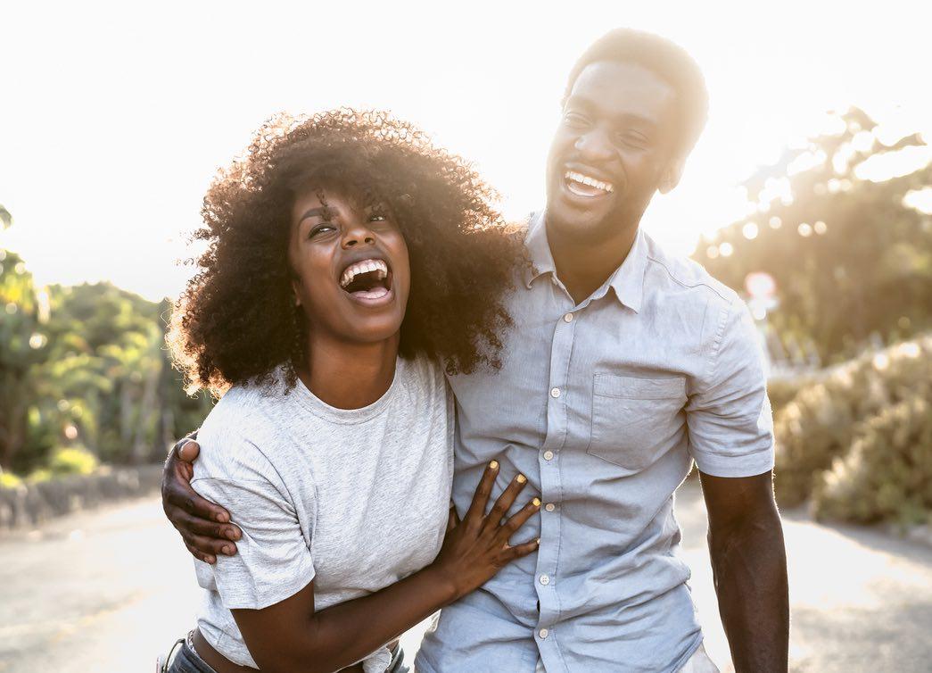 A couple laughing and enjoying a walk together