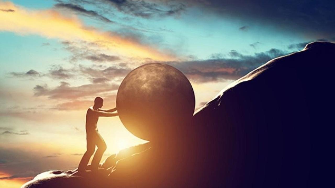 A stone moving up a hill, representing the effort of a journey